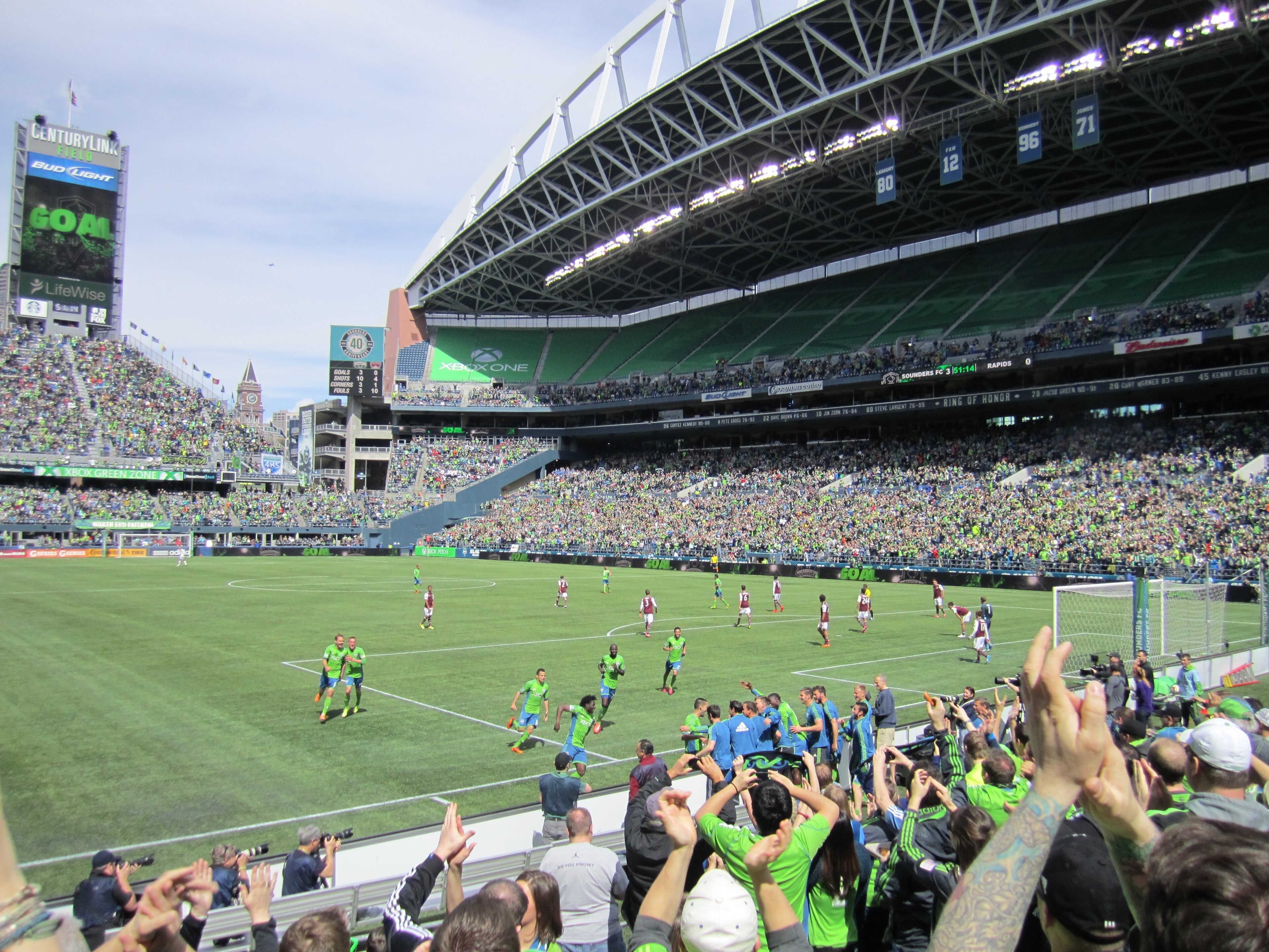 Seattle Sounders players celebrating in front of supporters