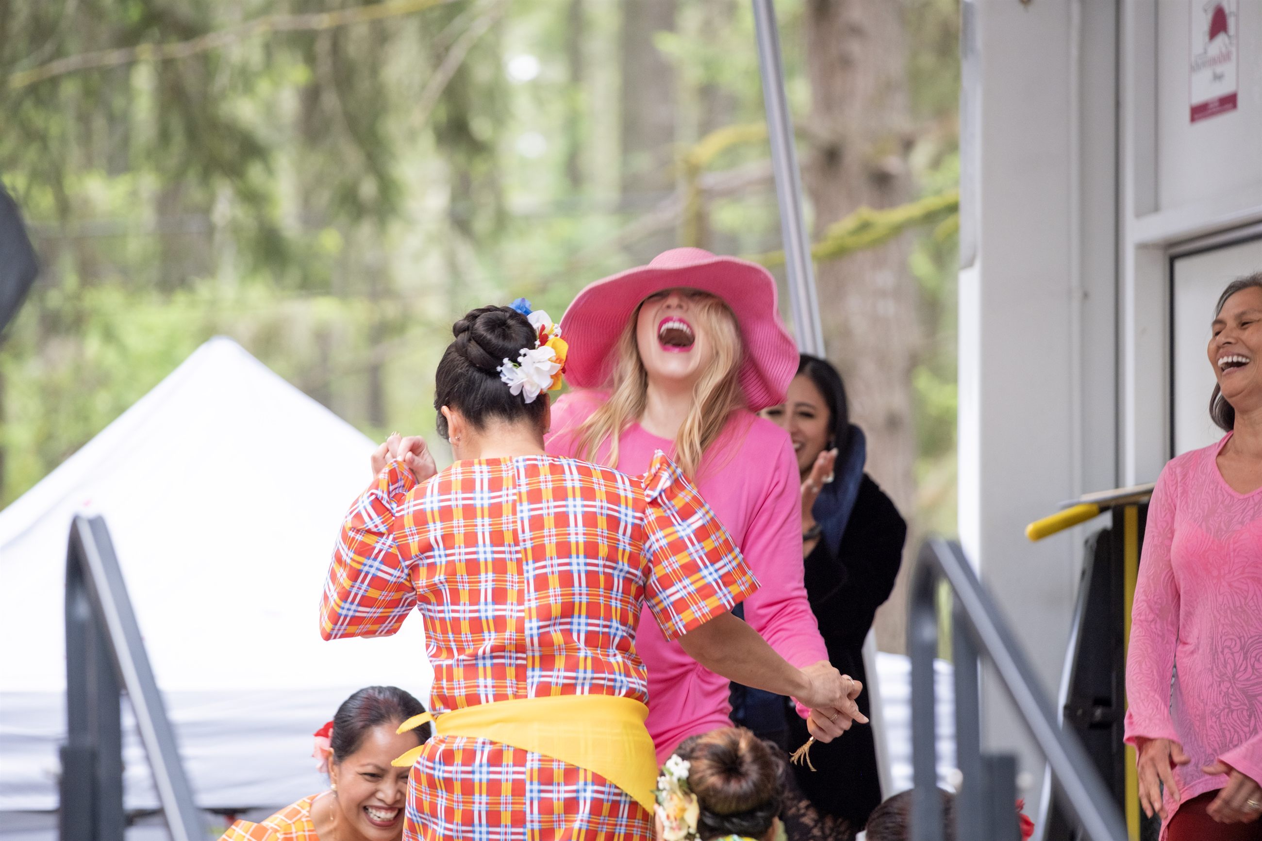 Volunteer greeters and guests connecting at the festival.