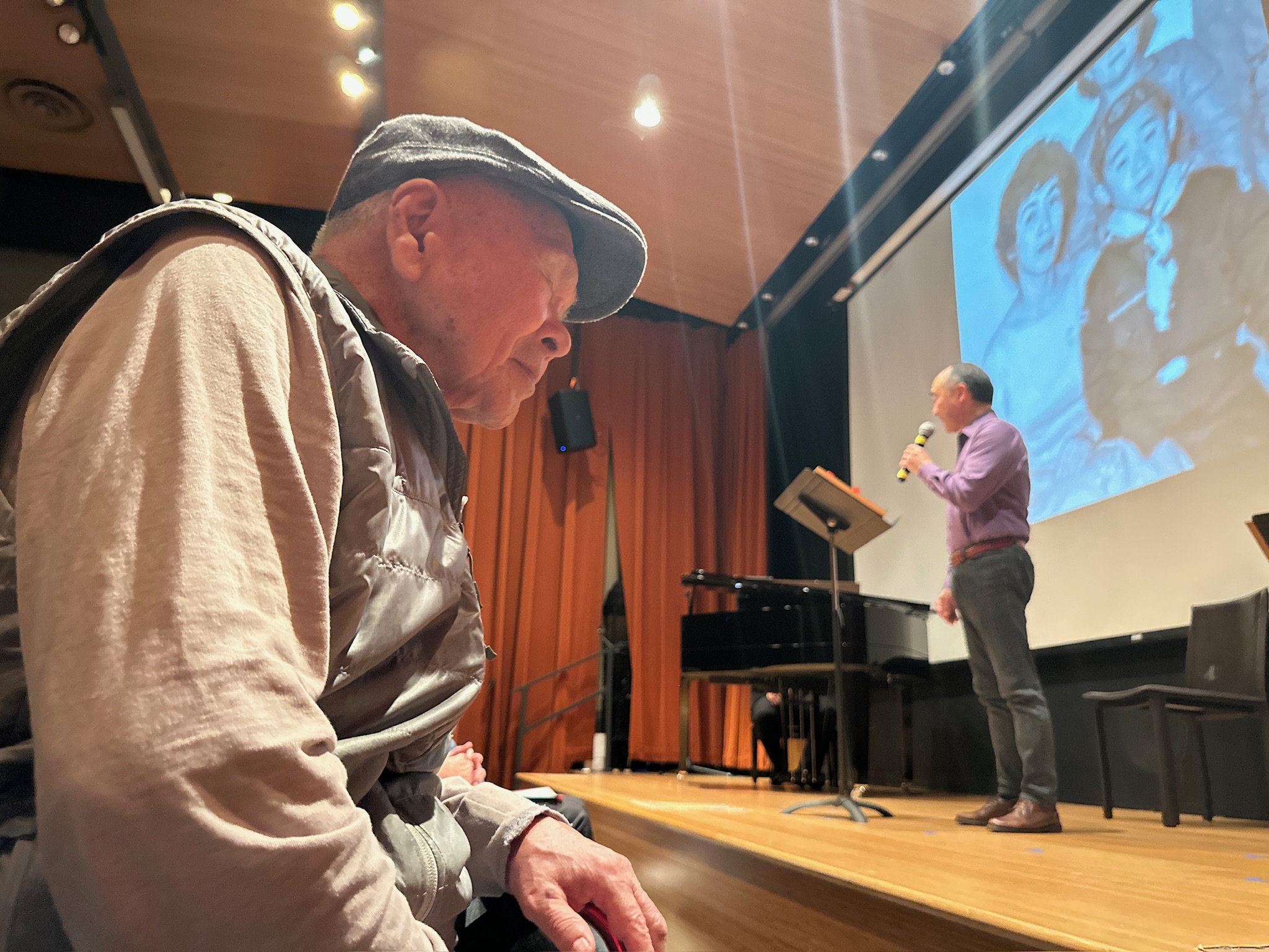 Festival performer on stage during a community event.